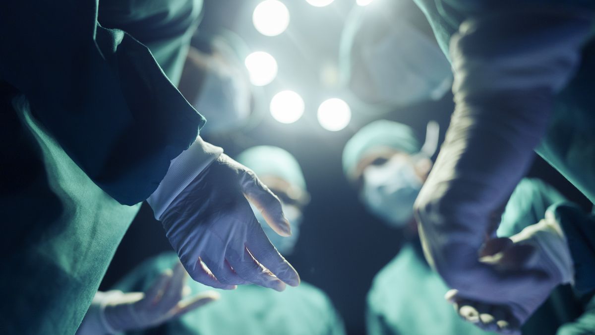 A stock photograph of four surgeons in discussion before an operation.