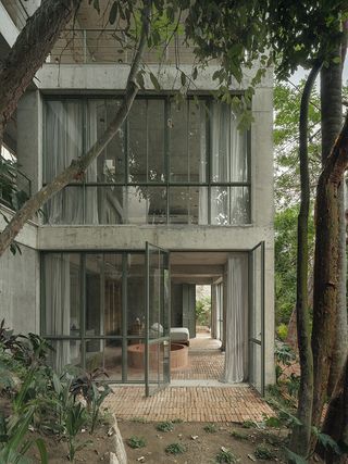 Nico Sayulita hotel concrete exterior detail among trees
