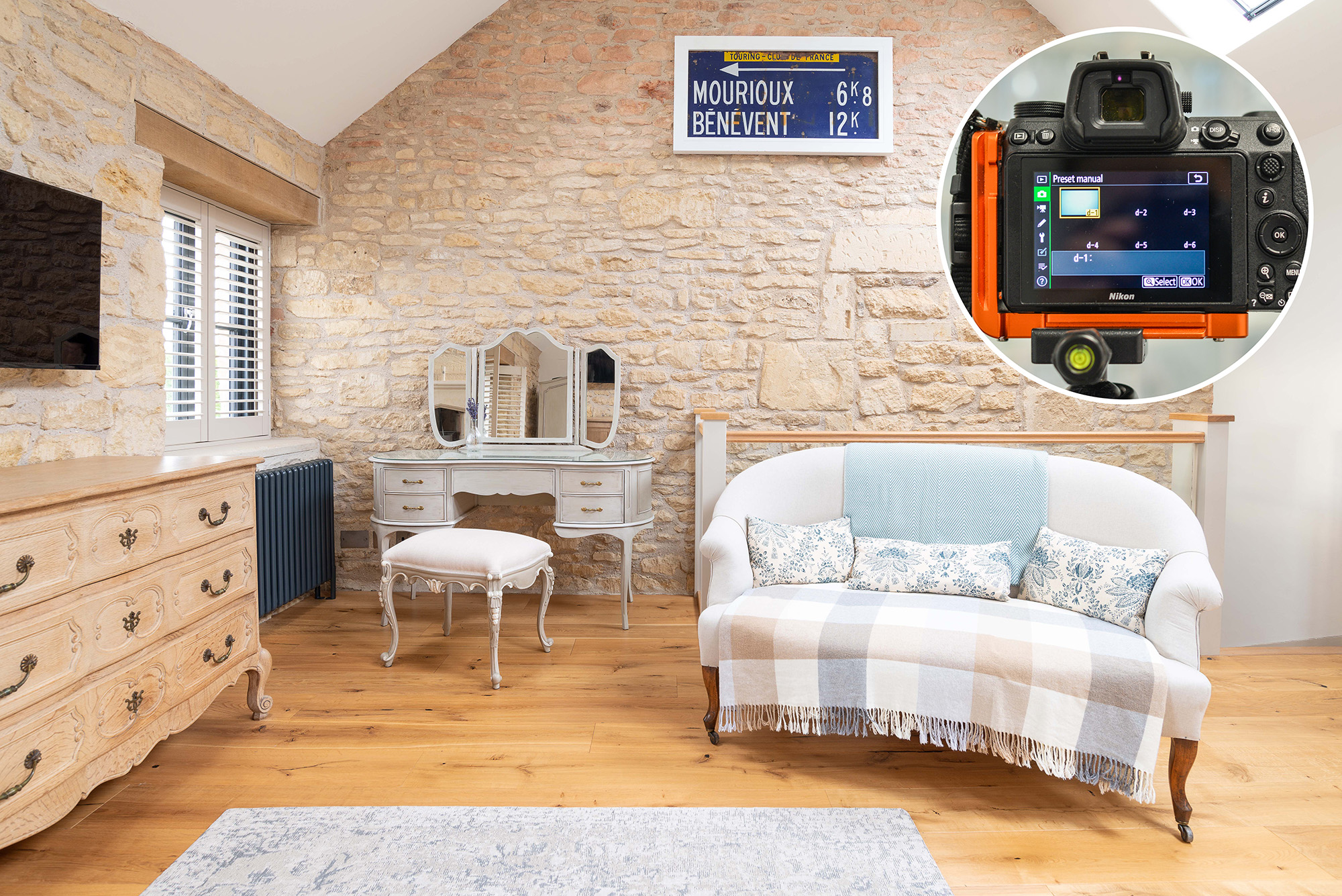 Stone walls with sofa and dresser and inset roundel of Nikon camera