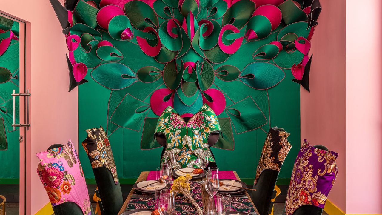 The Mandrake dining room with pink walls and a large table dressing