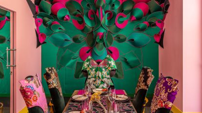 The Mandrake dining room with pink walls and a large table dressing