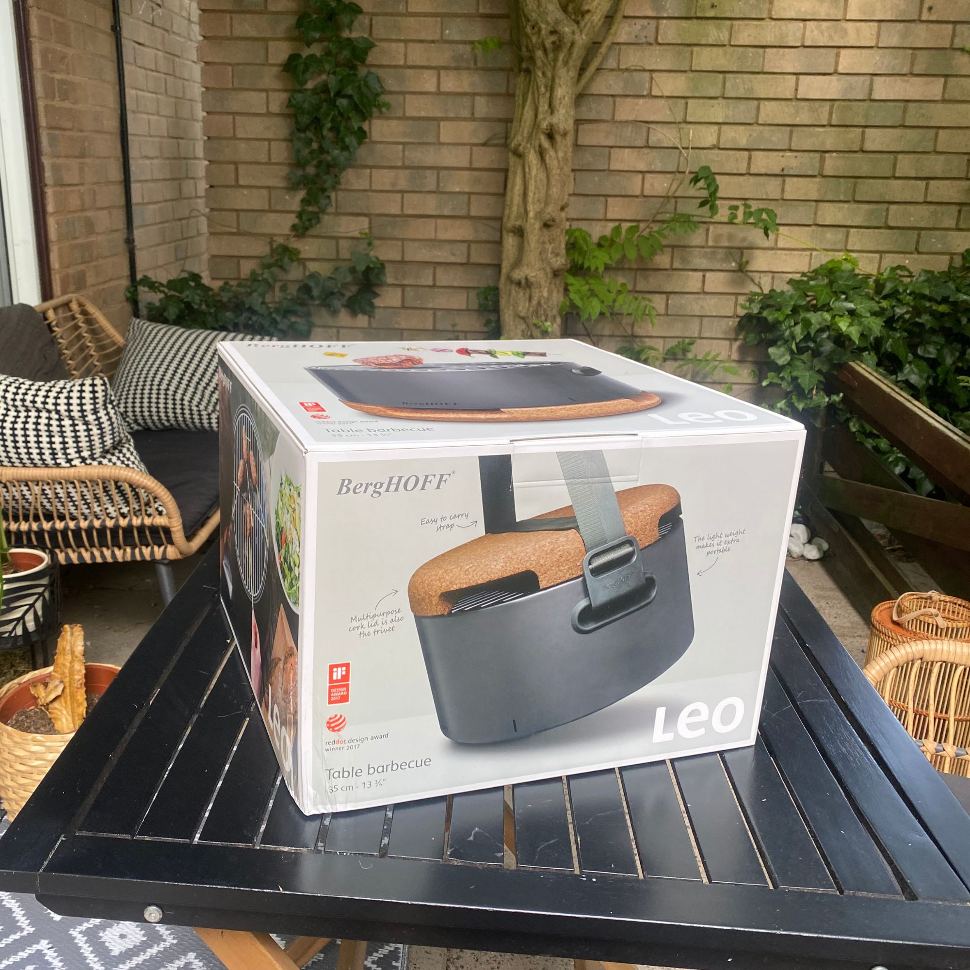 portable bbq in box on table in garden