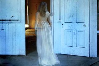 Ghostly woman walking through door