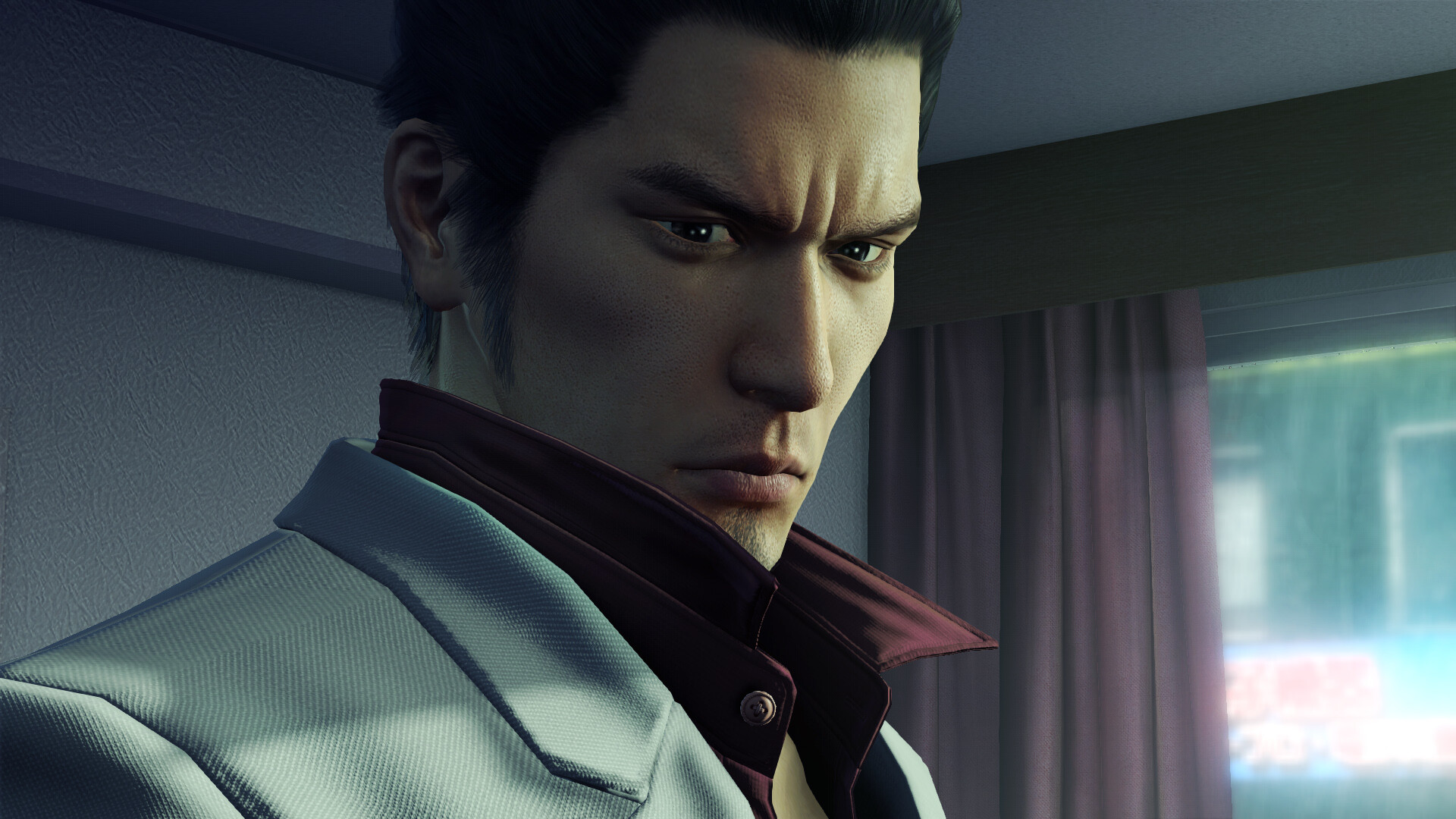 Protagonist Kiryu in Yakuza Kiwami stands with a pensive expression, looking over his shoulder
