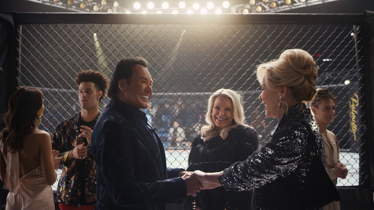 Wayne Newton and Jean Smart talk outside an octagon cage in Hacks