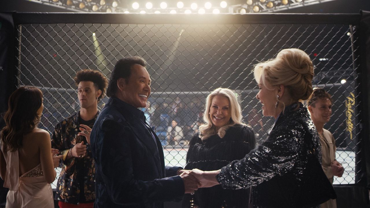 Wayne Newton and Jean Smart talk outside an octagon cage in Hacks
