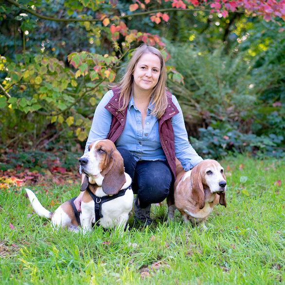 Caroline Wilkinson sitting between two dogs