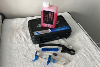 Hydraulic disc brake tips: A brake bleed kit and brake fluid for performing a full bleed