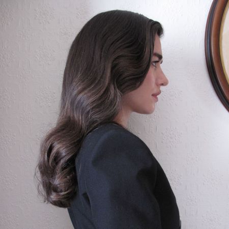 Creator Ilirida Krasniqi wearing a chic long haircut.