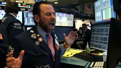 A trader reacts on the New York Stock Exchange on Black Monday 9 March. Photo by TIMOTHY A. CLARY/AFP via Getty Images