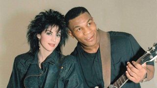 Hoan Hett and Mike Tyson pose with guitars in 1986