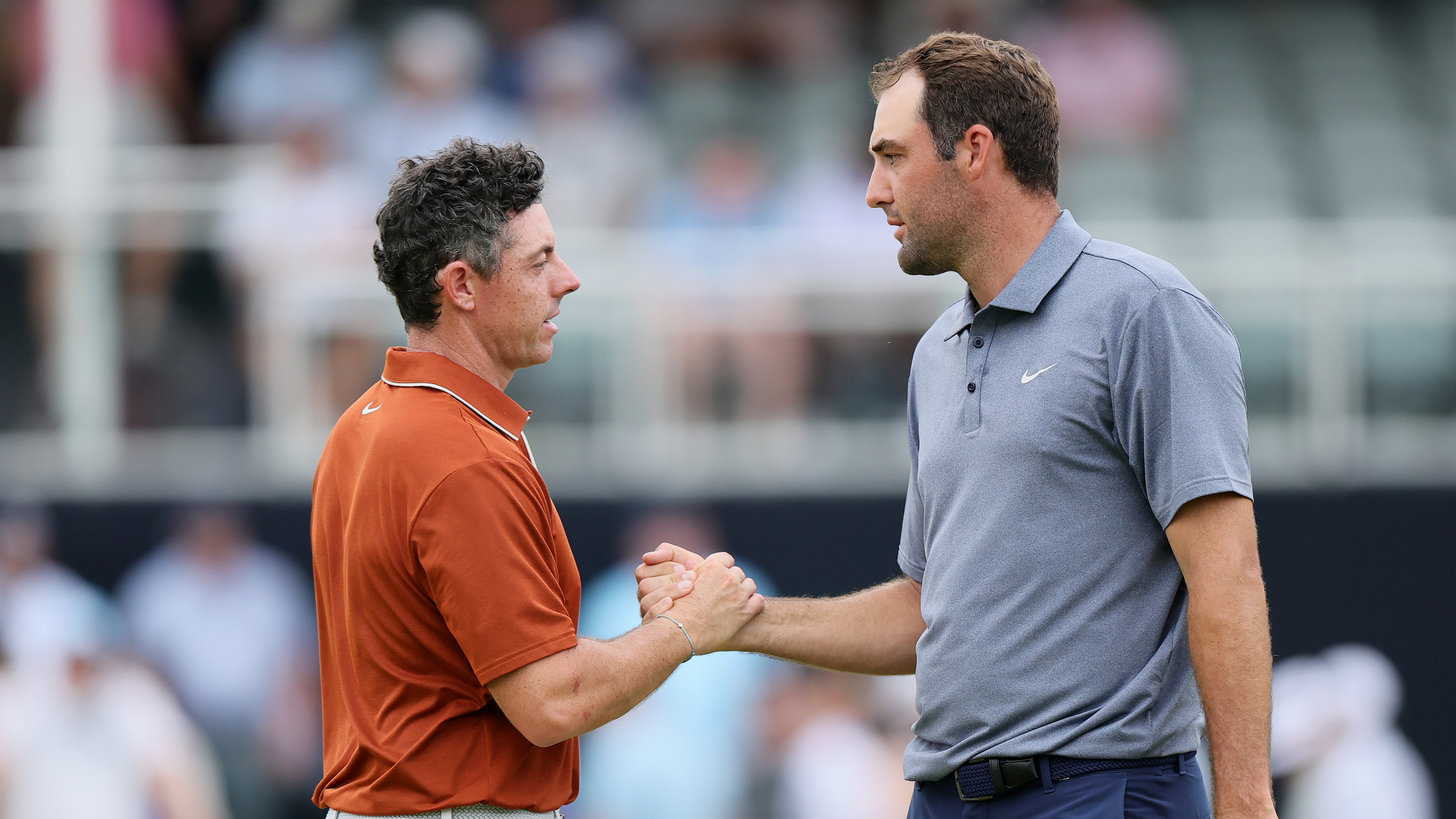 Rory McIlroy and Scottie Scheffler shake hands on the green at the PGA Championship