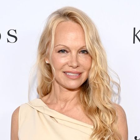 Pamela Anderson has loose blonde curls and minimal makeup as she attends The Daily Front Row Fashion Media Awards 2023 on September 08, 2023, wearing a cream one-shoulder dress