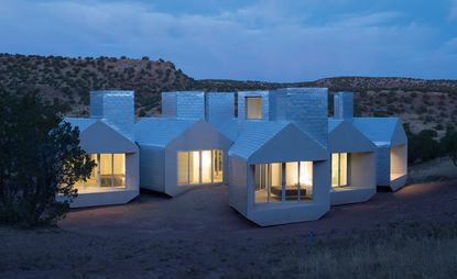 Multiple small, angular houses with square chimneys