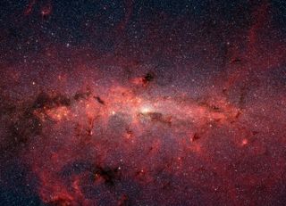 Galactic cores, like the center of the Milky Way seen in this photo, are full of gas and debris, making it very hard to get any direct images of the stars or black holes there.