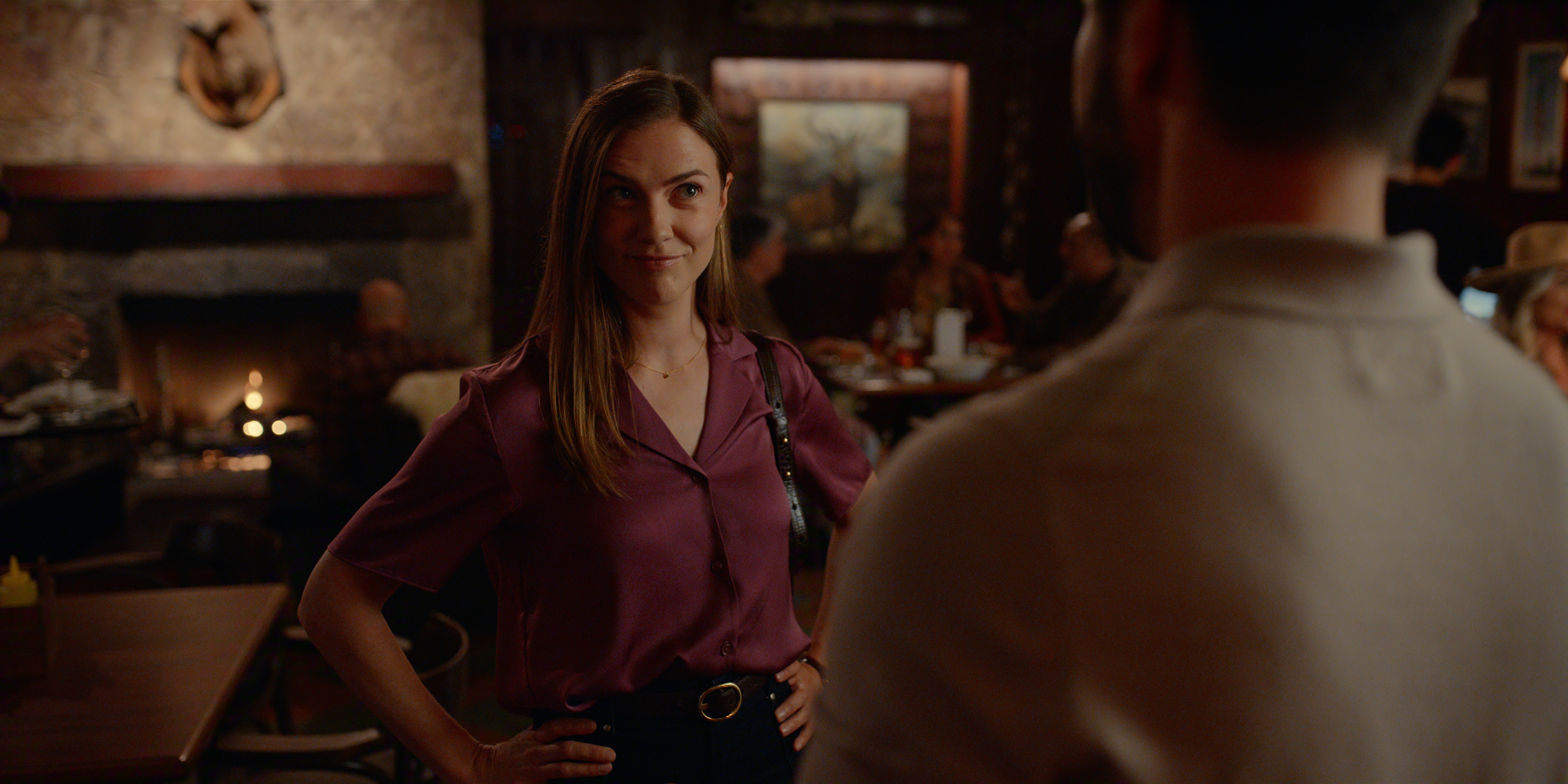 Sara Canning as Victoria in Episode #709 of Virgin River Season 7 holding her hands on her hips while meeting a man at a bar