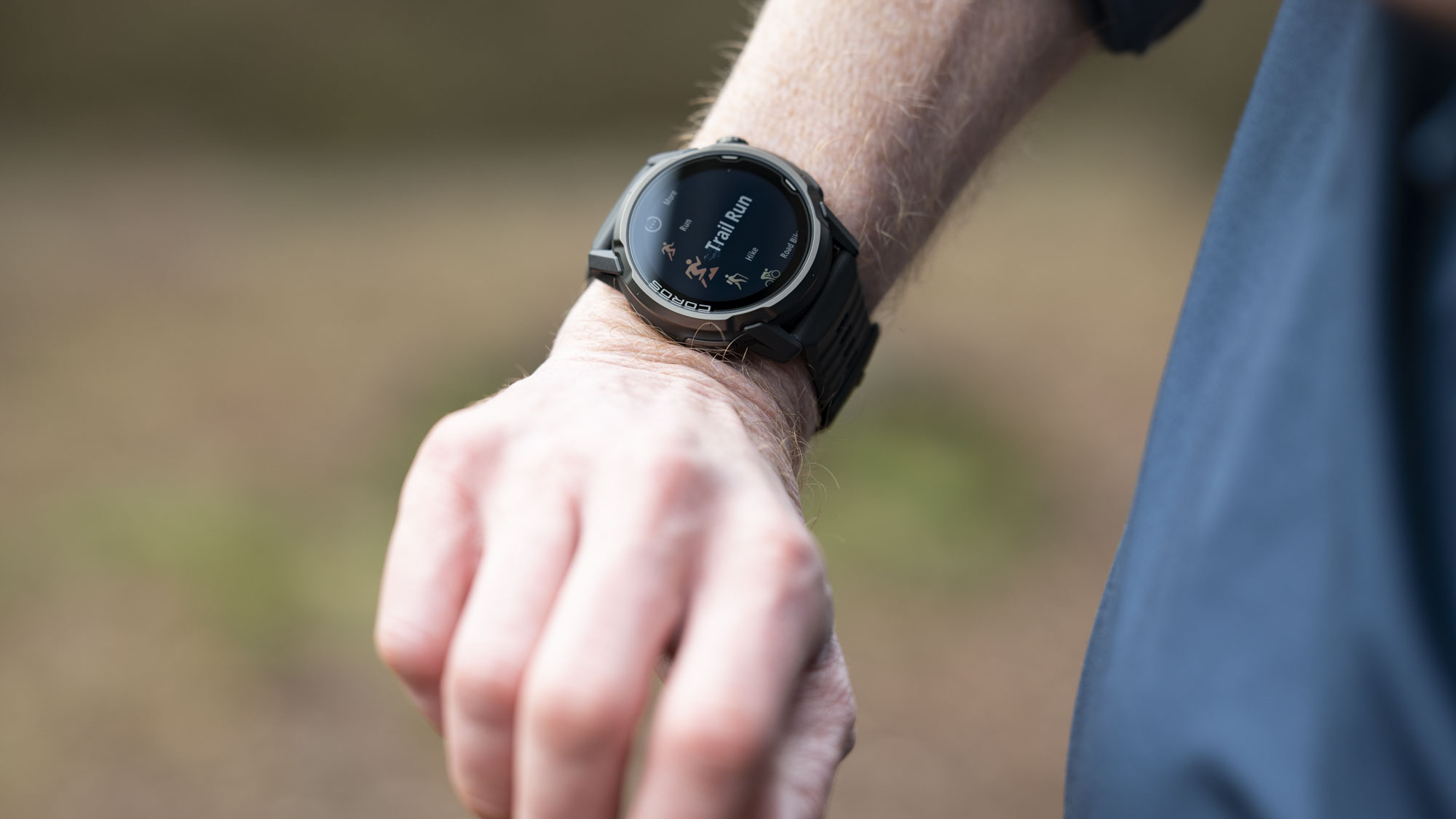 Coros Apex 4 running watch on athlete's wrist, they are starting an outdoor run