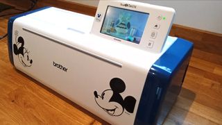 The best vinyl cutter machines, a photo of a Disney branded craft cutting machine on a wooden table