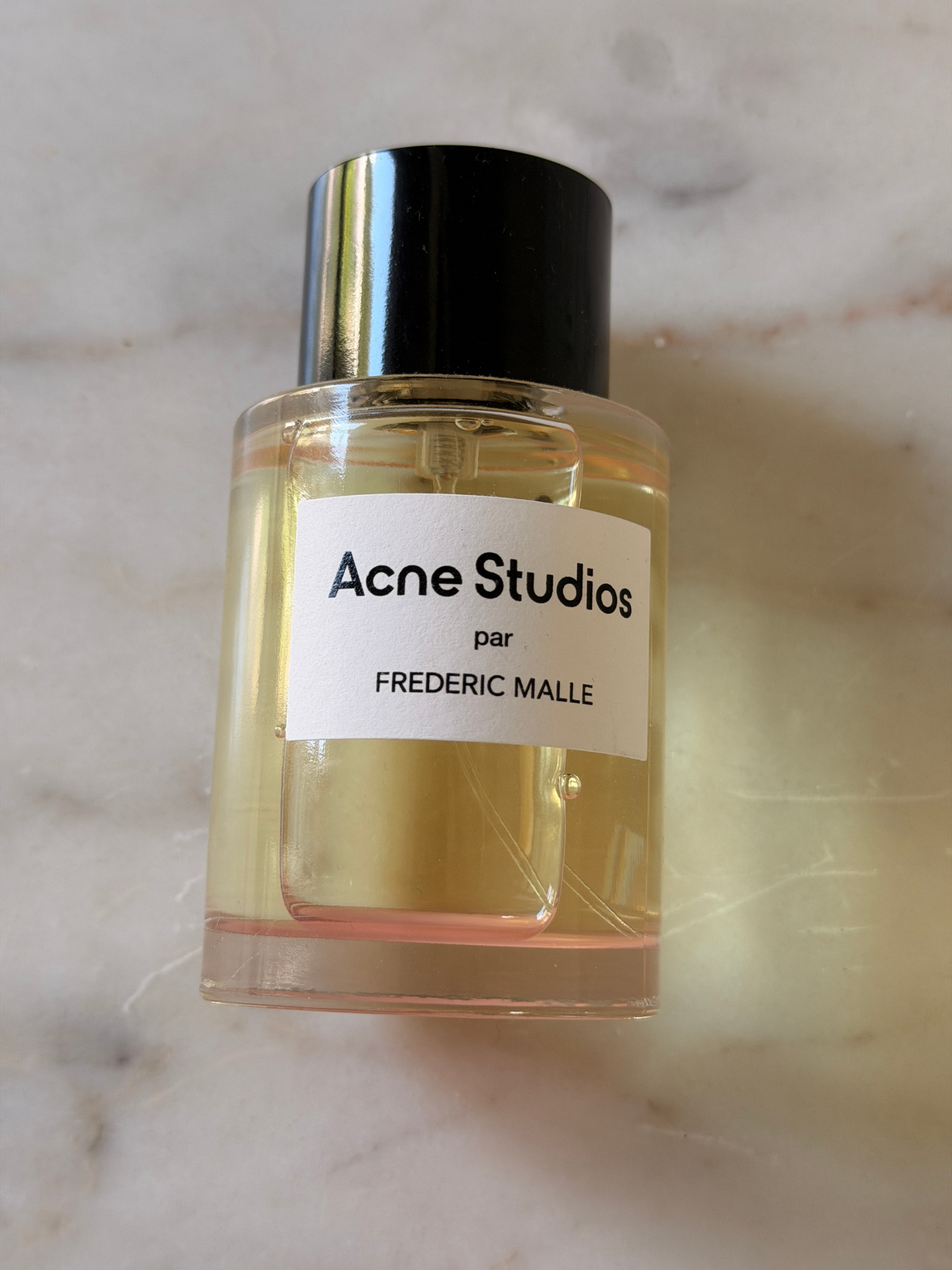 A bottle of Acne Studios par Frederic Malle perfume