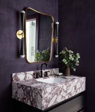 Purple painted bathroom with marble counters