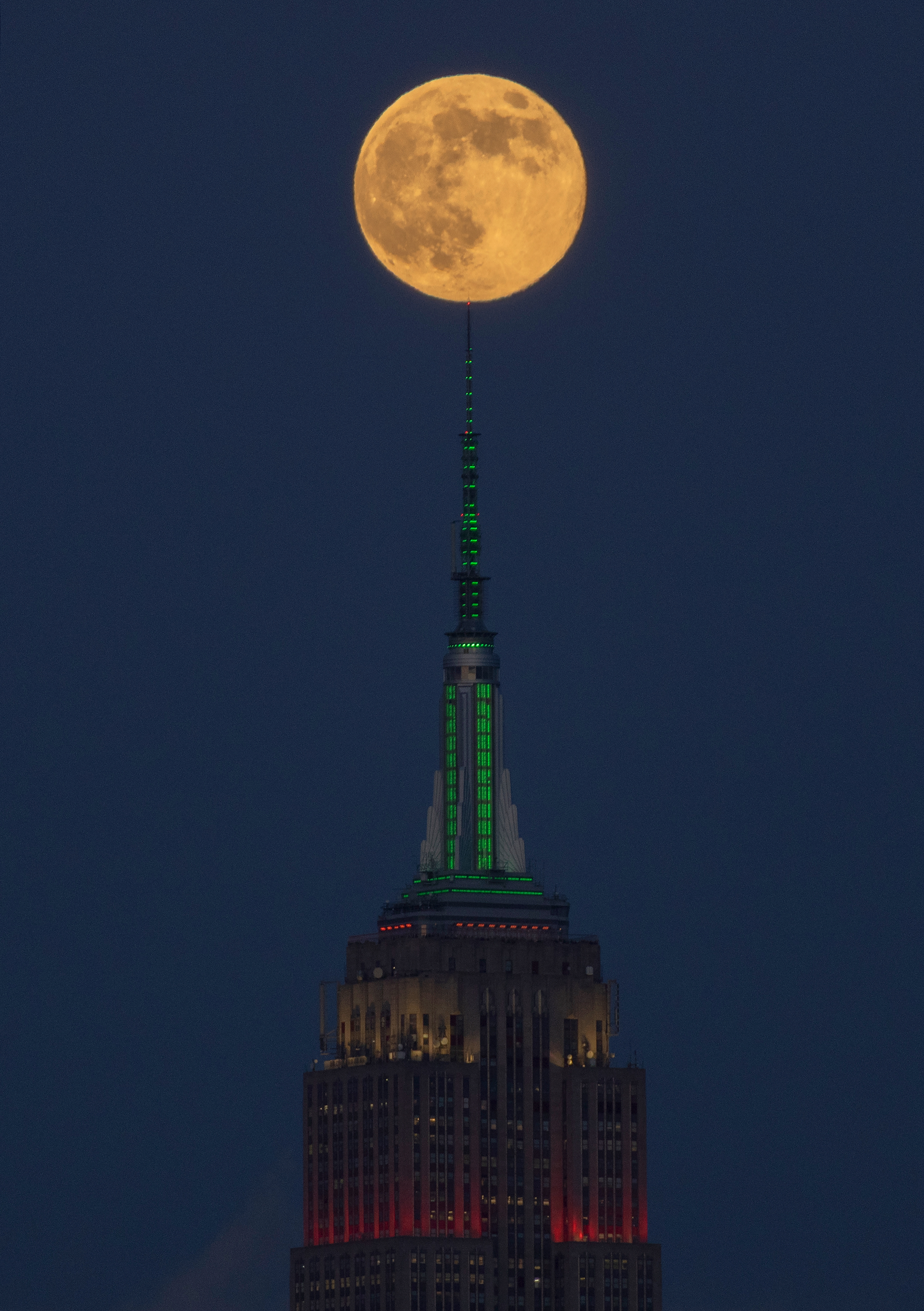 A photo of the &quot;Cold Supermoon&quot; rising over the Empire State Building in New York City.