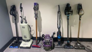 The vaccums which we tested lined up against a wall