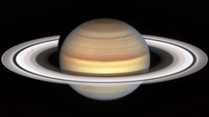 Saturn with two smudges on left side.