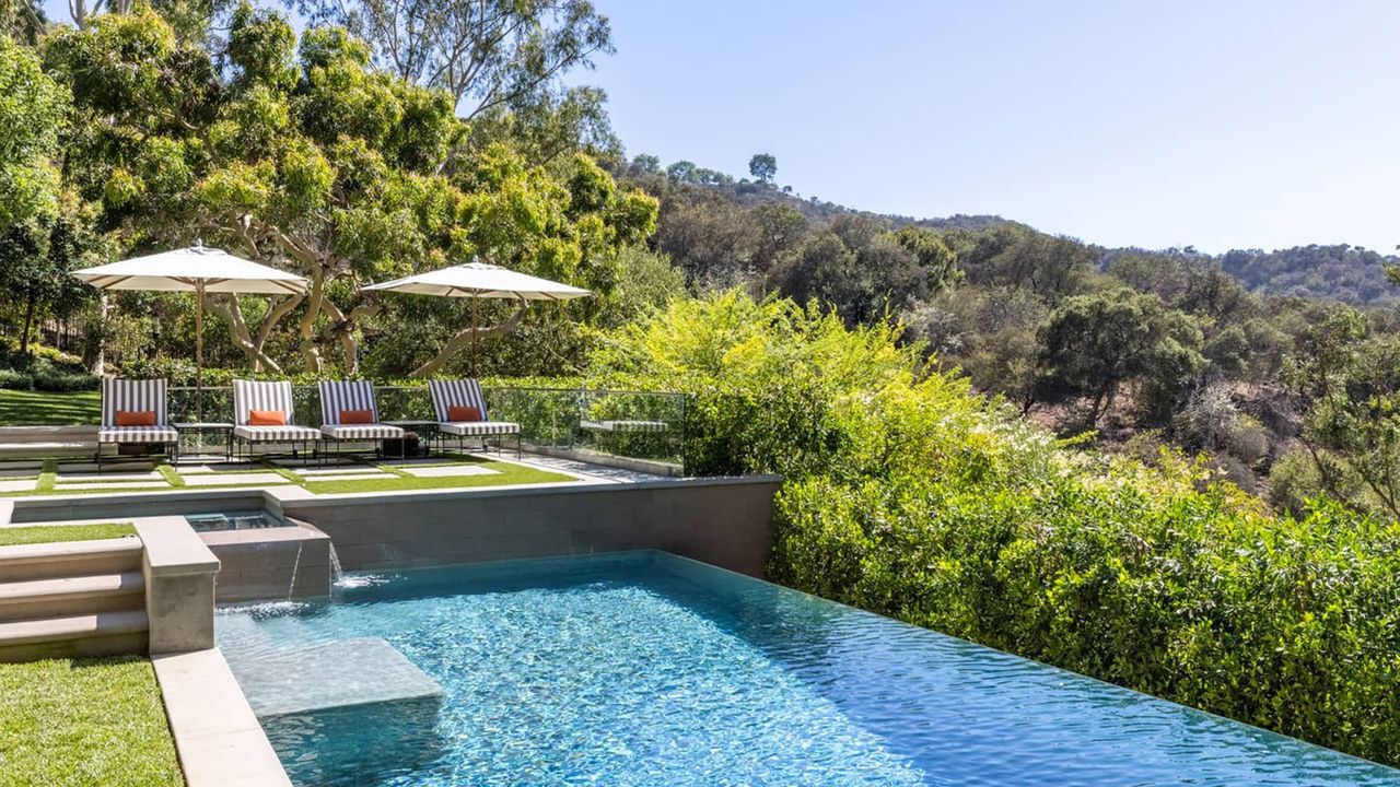 Infinity pool with deck chairs