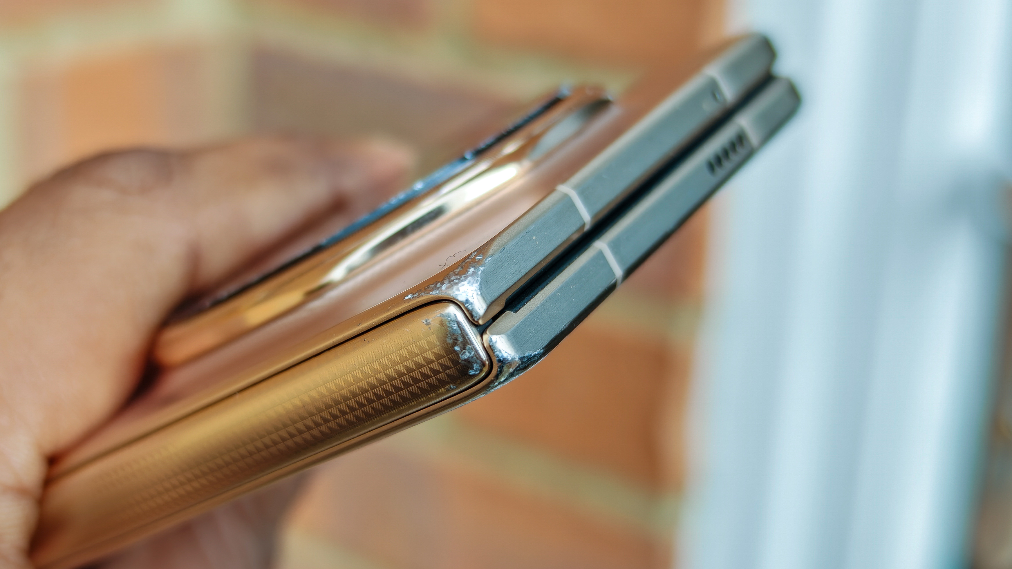 The Honor Magic V6 in gold after being put through a washing machine, complete with scratches and blemishes but fully working. 