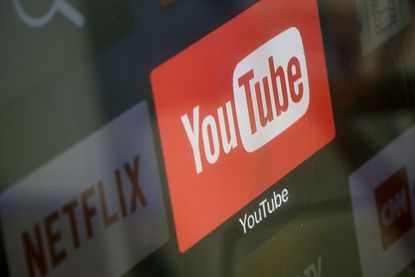The YouTube and Netflix app logos are seen on a television screen on March 23, 2018 in Istanbul, Turkey.