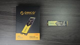 An Orico O7000 SSD on a table with its retail packaging