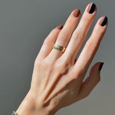 Photo of Betina Goldstein's hand with painted nails wearing a Chanel ring
