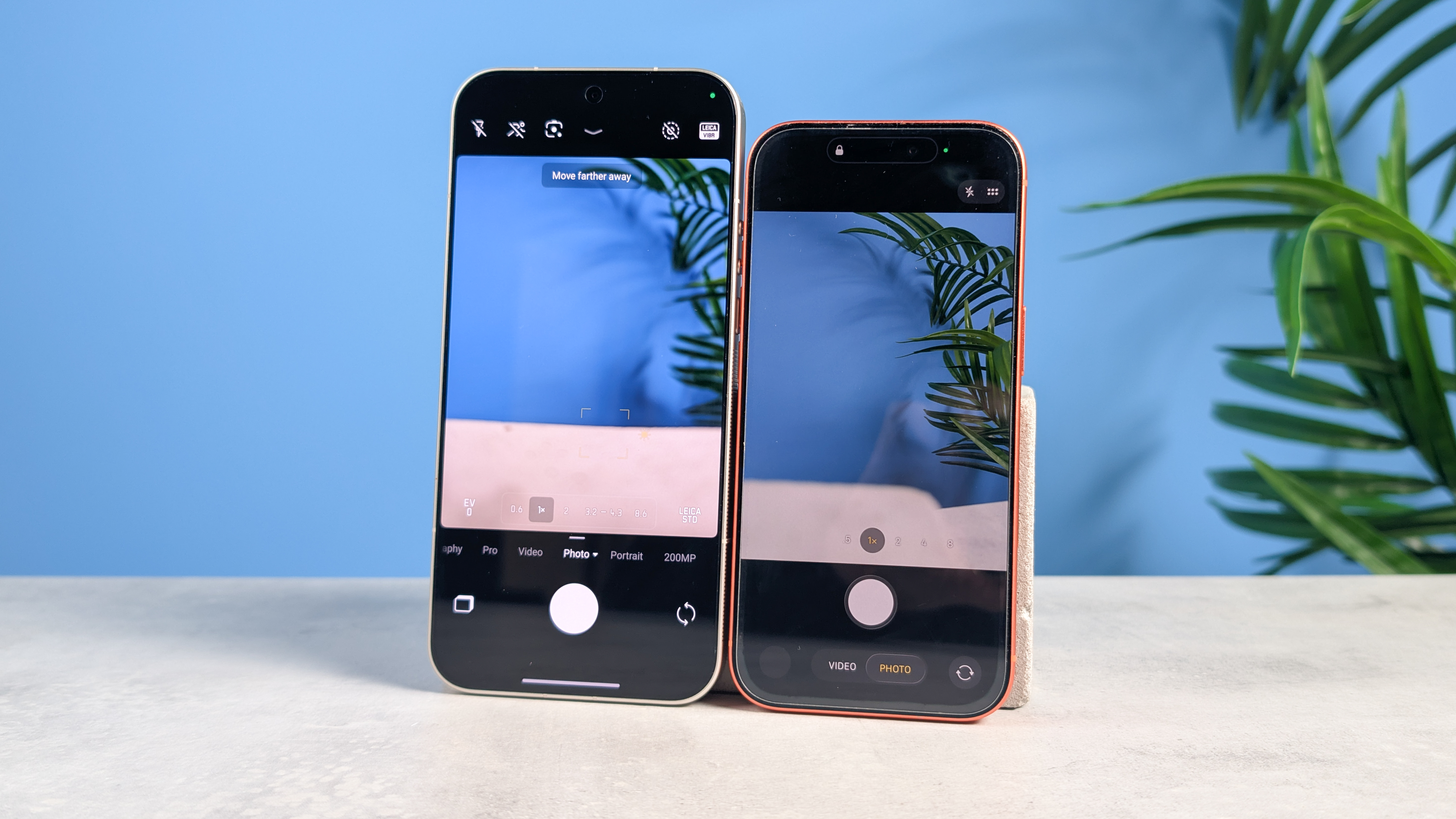 A black Leica Leitzphone and an orange iPhone 17 Pro
