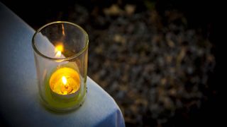 Candle burning in a garden