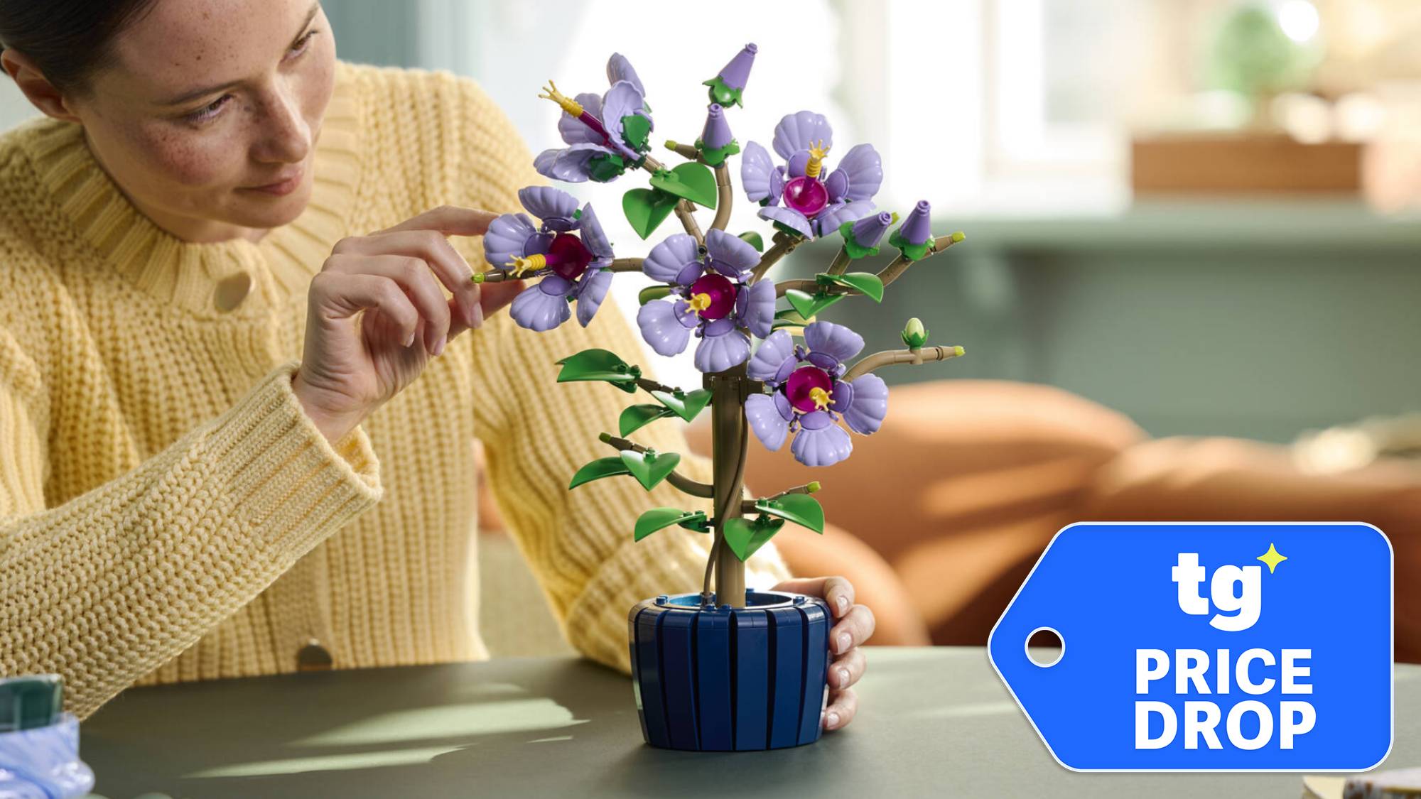 Person building a Lego Botanicals Hibiscus set