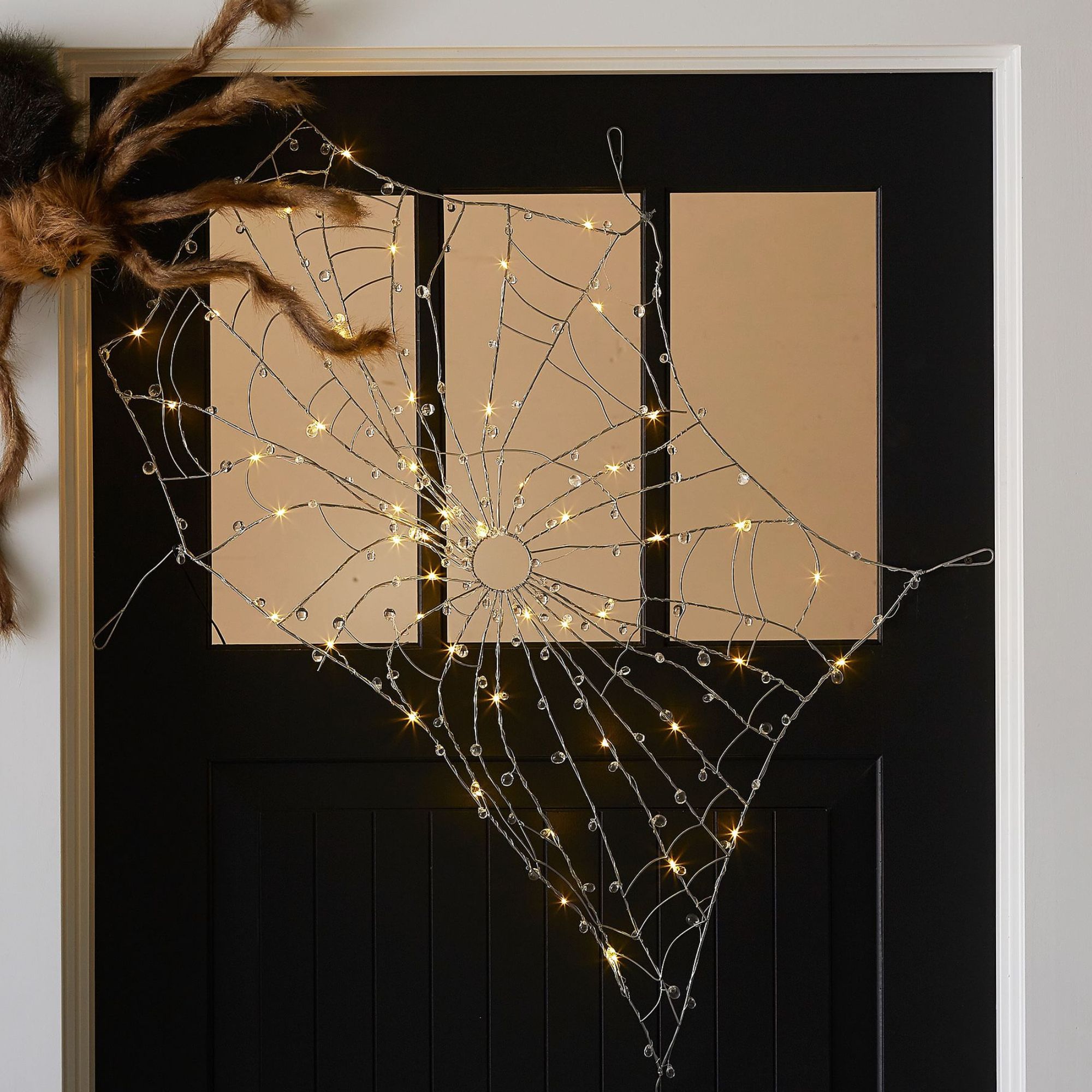 Lit spider web decoration
