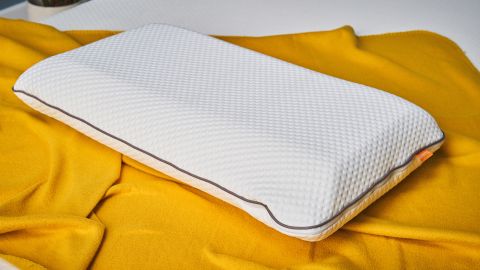 The Emma Original Pillow on a yellow blanket