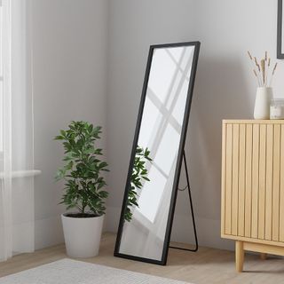 Dunelm Essentials Freestanding Mirror with a plant next to it