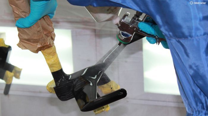 The inverted fork, stem and bar combo receiving a clear lacquer coat