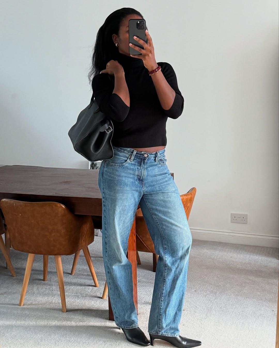 woman wearing black turtleneck outfit fall 2025