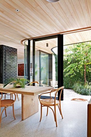Open plan dining room with bi-fold doors onto garden