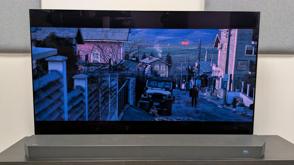 The Running Man (2025) 4K Blu-ray on LG G5 OLED showing Ben walking uphill in a suburb
