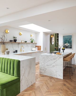kitchen with marble island and peninsula and velvet green upholstered seating