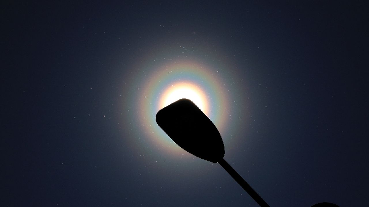 The rainbow rings behind a lamp post