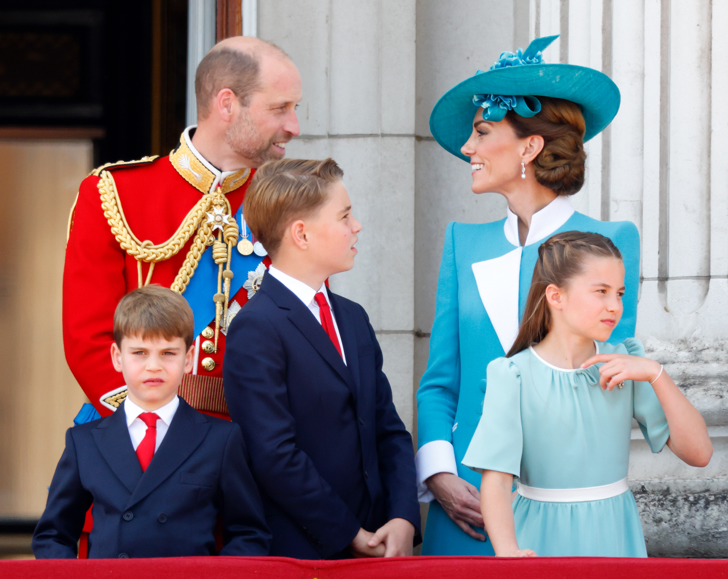 Kate Middleton and Prince William talking on the Buckingham Palace balcony at Trooping the Colour
