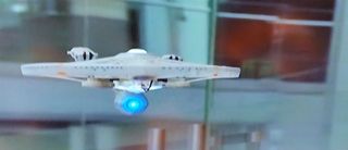 The Air Hogs USS Enterprise NCC-1701A quadcopter drone can be seen in action in this still from a Spin Master video.