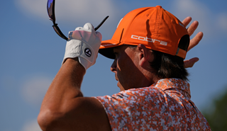 Rickie Fowler adjust his cap