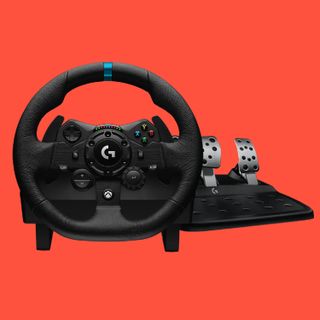 The easiest racing wheel for beginners, the Logitech G923 Trueforce on a red background, with pedals