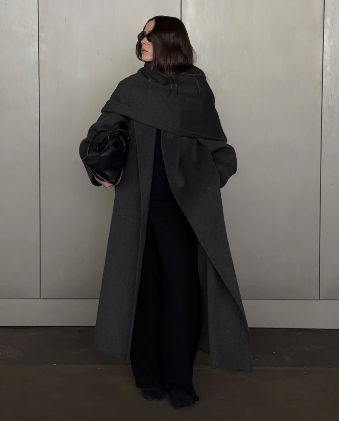Lena Herrmann wearing a long gray coat with a cape.