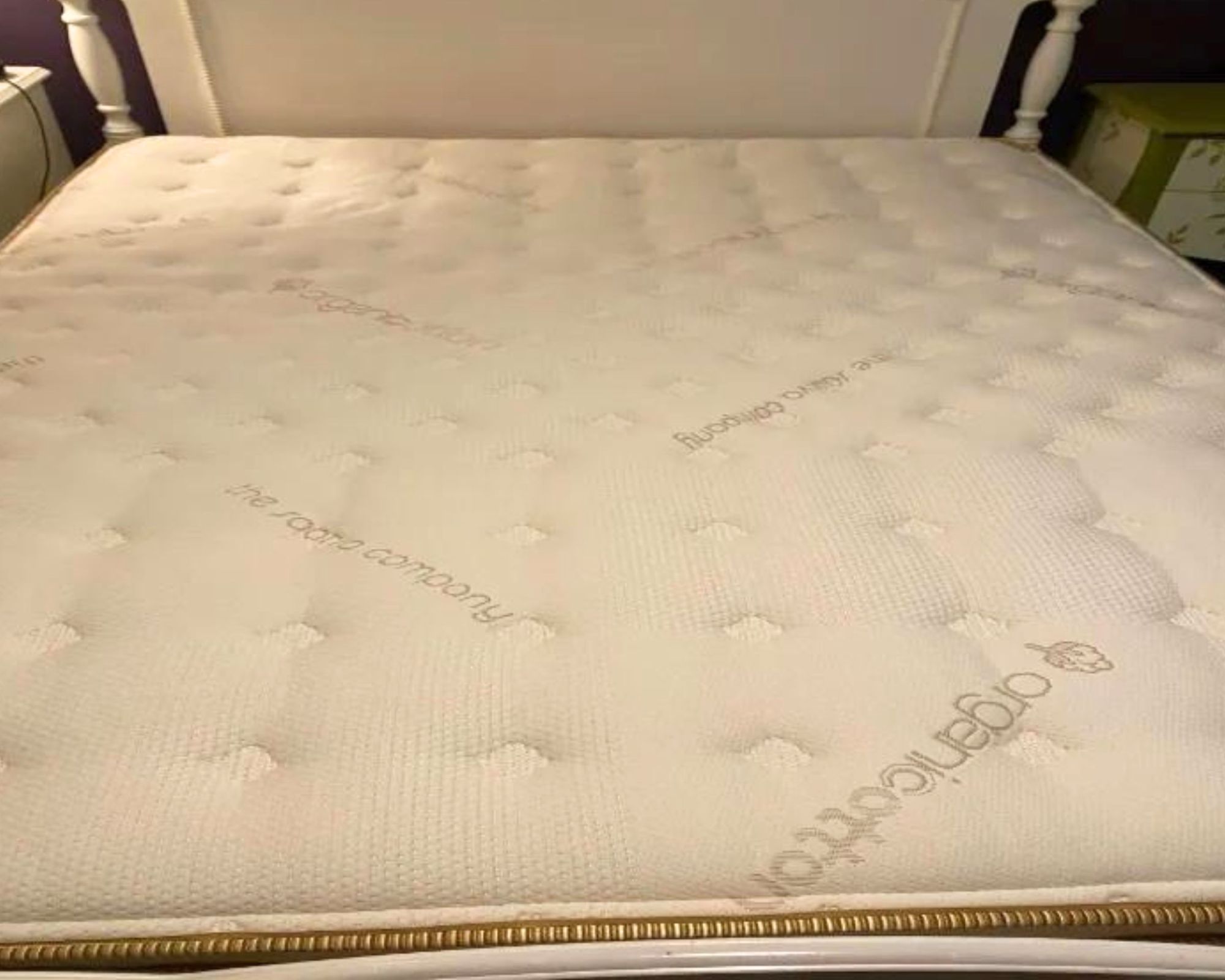 A close-up of the Saatva Classic Mattress on a white bed.